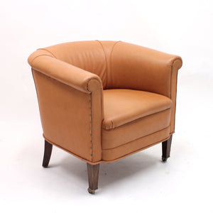 Brown leather club chair on castors, 1930s