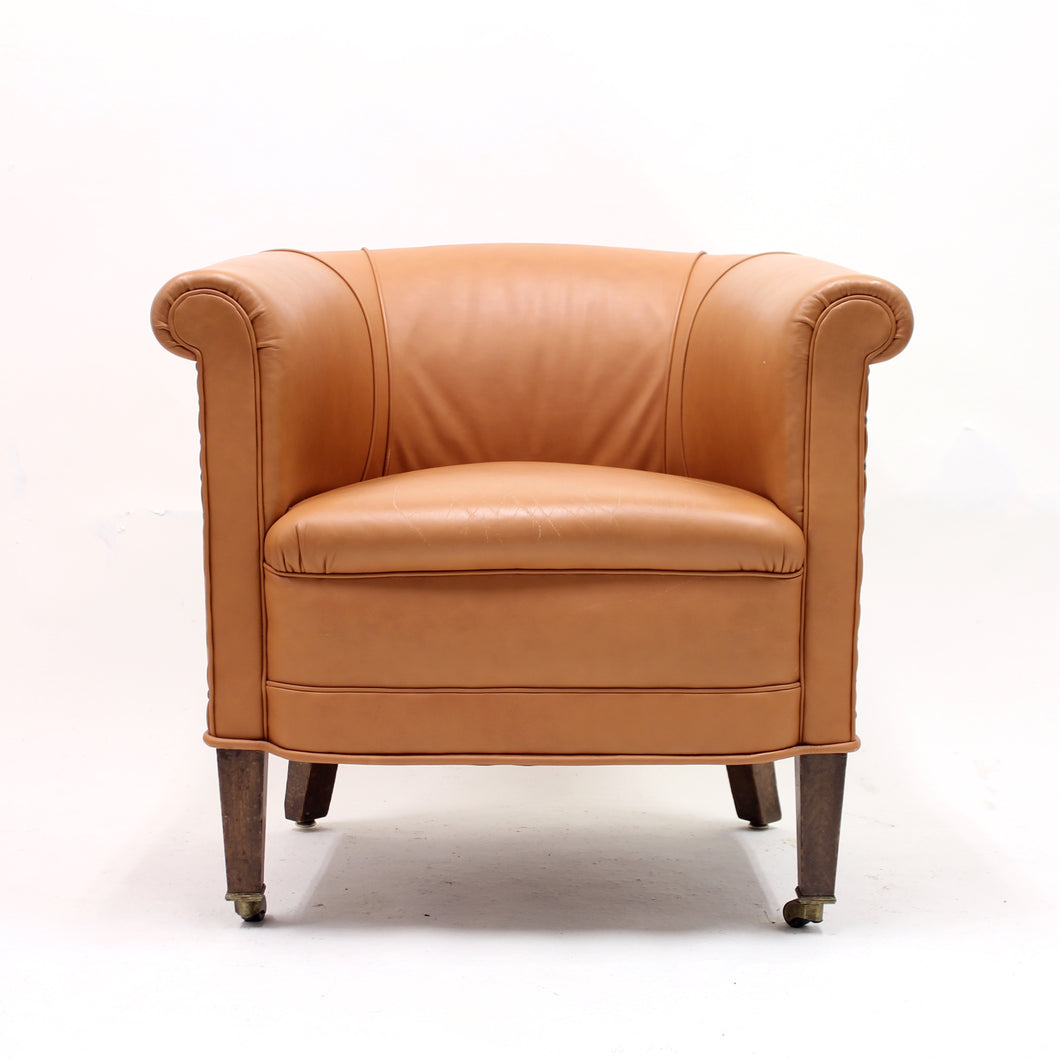 Brown leather club chair on castors, 1930s