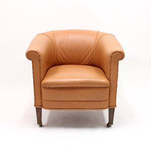 Brown leather club chair on castors, 1930s