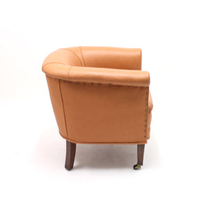 Brown leather club chair on castors, 1930s
