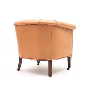Brown leather club chair on castors, 1930s