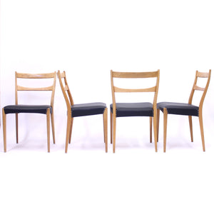 Scandinavian oak dining chairs with black leather seats, 1950s