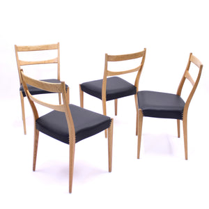 Scandinavian oak dining chairs with black leather seats, 1950s